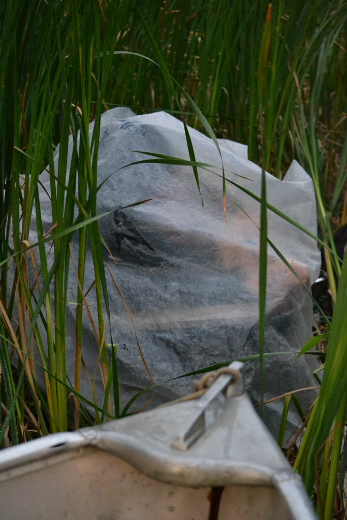 IBA Birders huddle under vapor barrier 'igloo' during Netly-Libau marsh's   vicious, July 2012 storm.