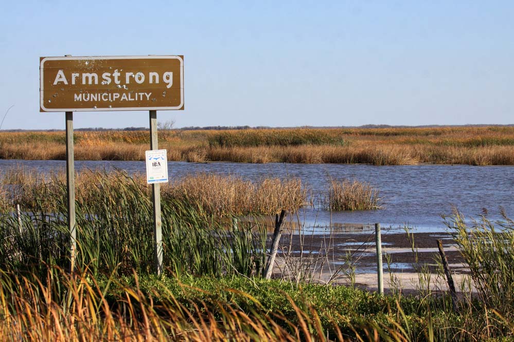 North, West and East Shoal Lake sign below the RM of Armstrong sign. Note that the bullet holes in the RM sign. Classy! Photo copyright Christian Artuso